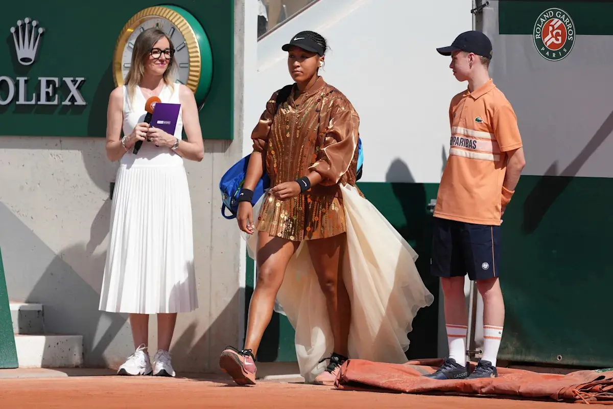 Naomi Osaka's latest French Open fashion ensemble includes an ivory train and gold jacket